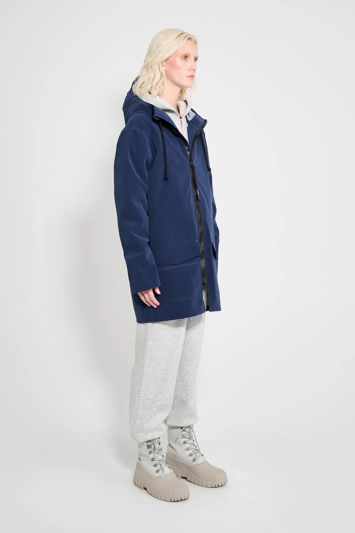Stockholm Patch Navy Raincoat worn by model, showcasing its oversized fit and waterproof features.
