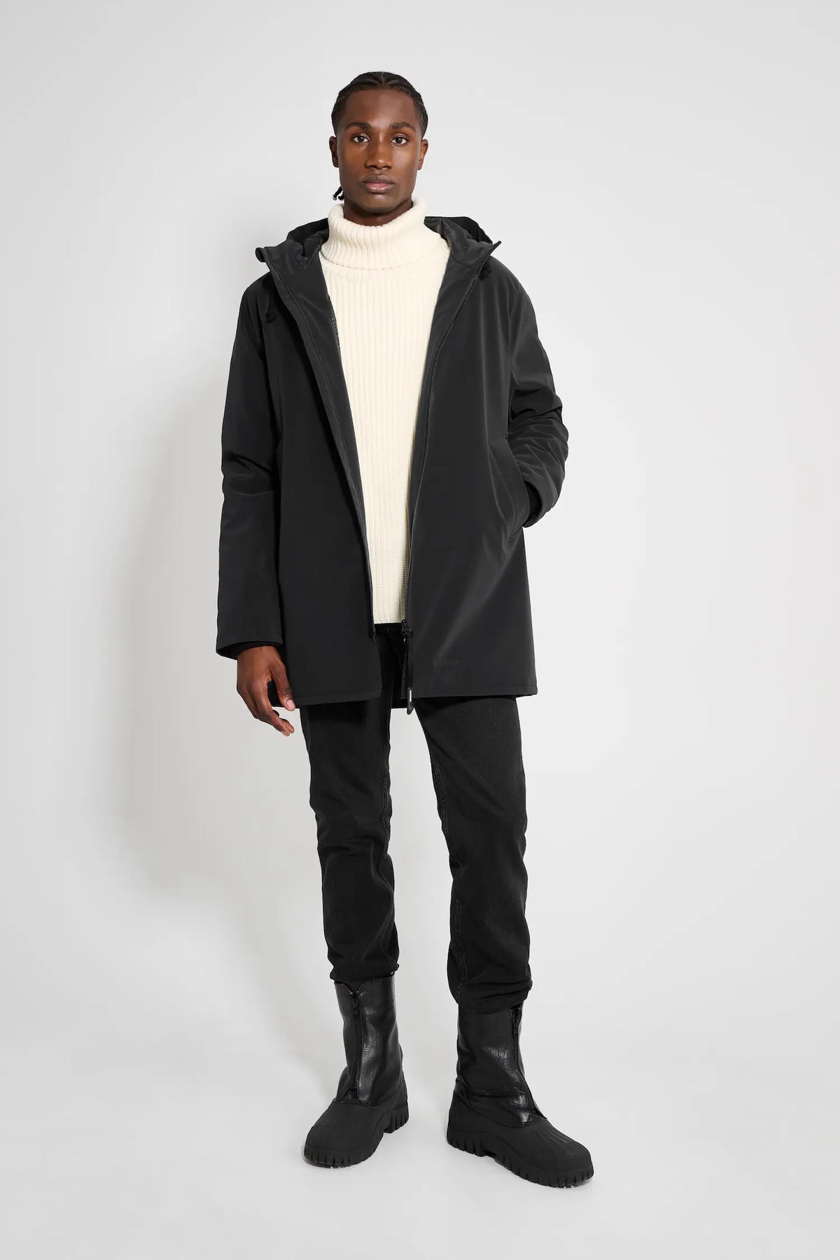 Model wearing the Stockholm Matte Black Winter Coat, showcasing its stylish design and functional features.