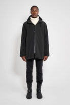 Stockholm Matte Black Winter Coat on model with adjustable hood, showcasing a straight oversized fit.
