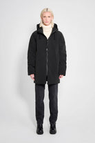 Model wearing the Stockholm Matte Black Winter Coat, showcasing its stylish oversized fit and adjustable hood.