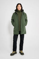 Model wearing the Stockholm Matte Green Winter Coat with a turtleneck and pants.