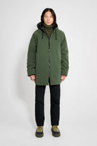 Stockholm Matte Green Winter Coat on model showcasing unisex oversized fit and adjustable drawstring hood.