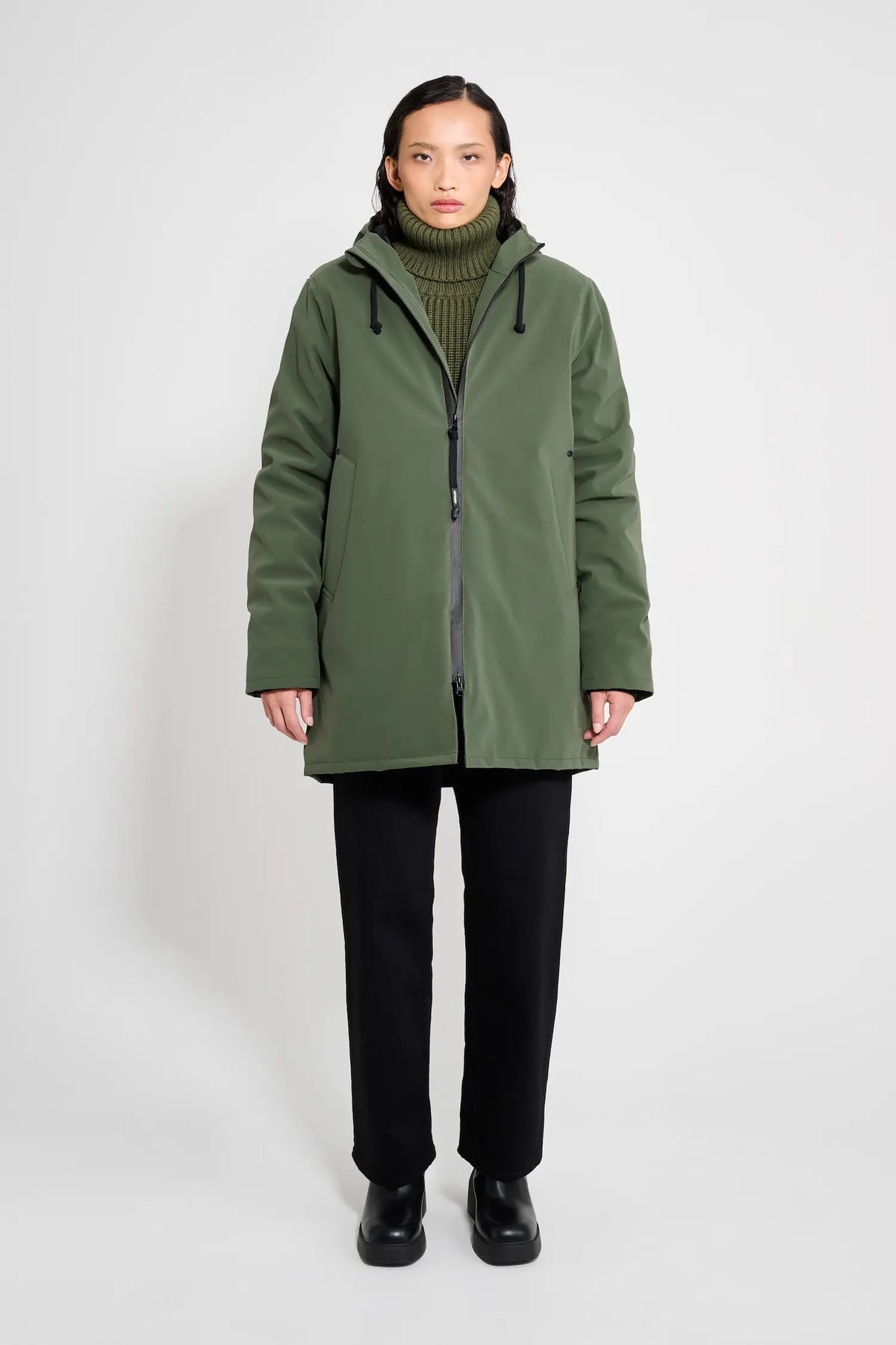 Stockholm Matte Green Winter Coat displayed on a model wearing a green turtleneck and black pants.
