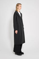 Wayfair Black Trench Coat displayed in a side view, showcasing waterproof fabric and oversized fit.