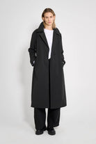 Wayfair Black Trench Coat displayed on model with oversized fit and hidden button closure.