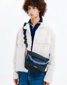 Besace Ecru Matt Coated Bag shown on model with unique strap design, ideal for daily accessories.