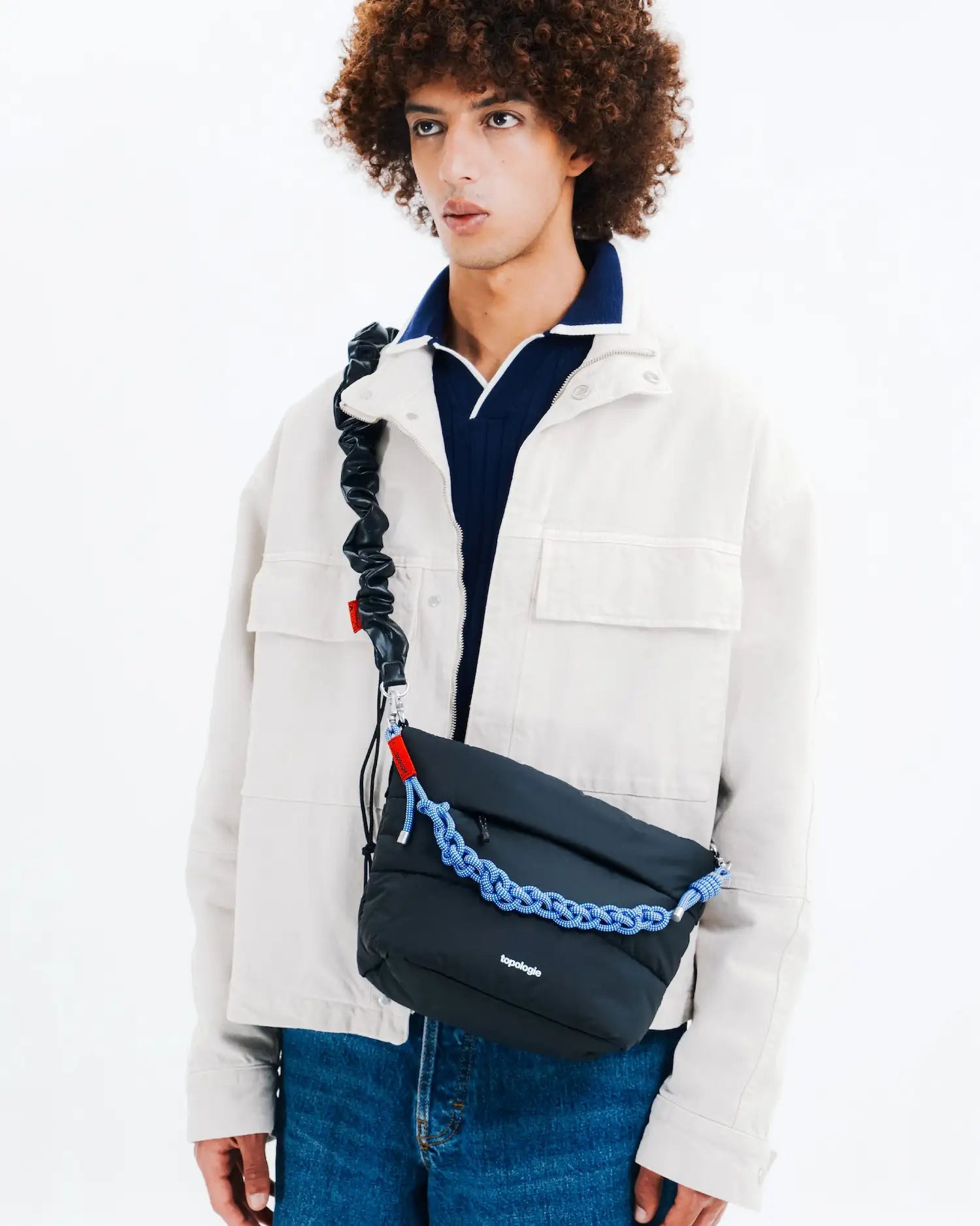 Besace Ecru Matt Coated Bag shown on model with unique strap design, ideal for daily accessories.