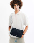 Bottle Sacoche Large Black Silky Peach Bag worn by model in trendy outfit
