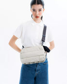 Model wearing the Bottle Sacoche Large Black Silky Peach Bag with a stylish outfit.