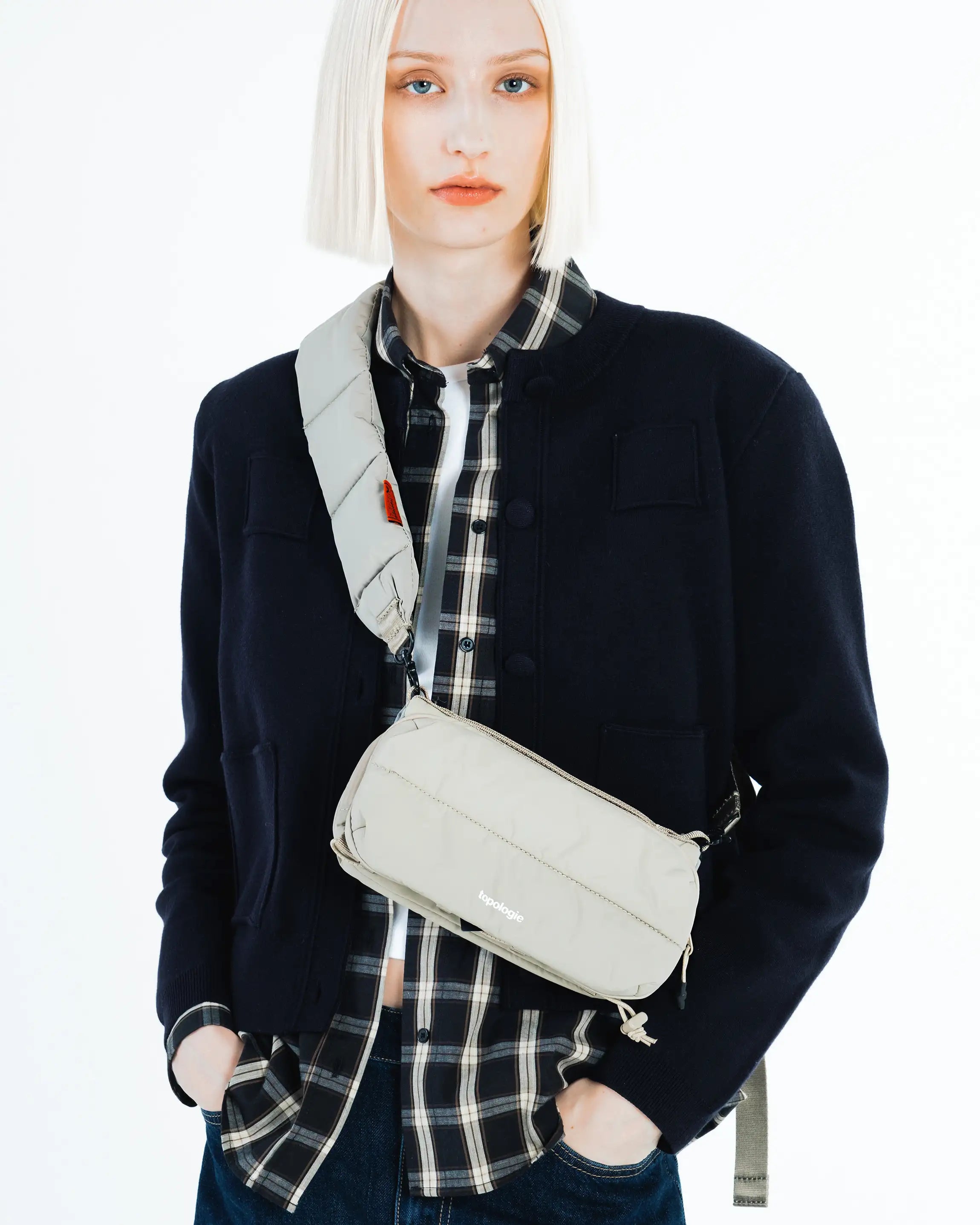 Bottle Sacoche Medium Blue Check Wool Bag displayed on model, featuring a stylish design with a unique strap.