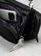 Bottle Sacoche Medium Moss Silky Peach Bag showing internal pockets with a phone and key hook.