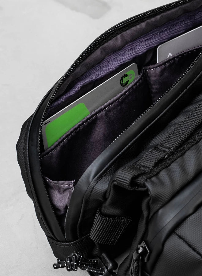 Interior view of the Bottle Sacoche Medium Ivy Green Papery Bag showing zipped compartments and internal pockets.