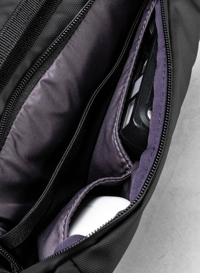 Interior view of the Bottle Sacoche Medium Ivy Green Papery Bag showcasing compartments and pockets for organization.