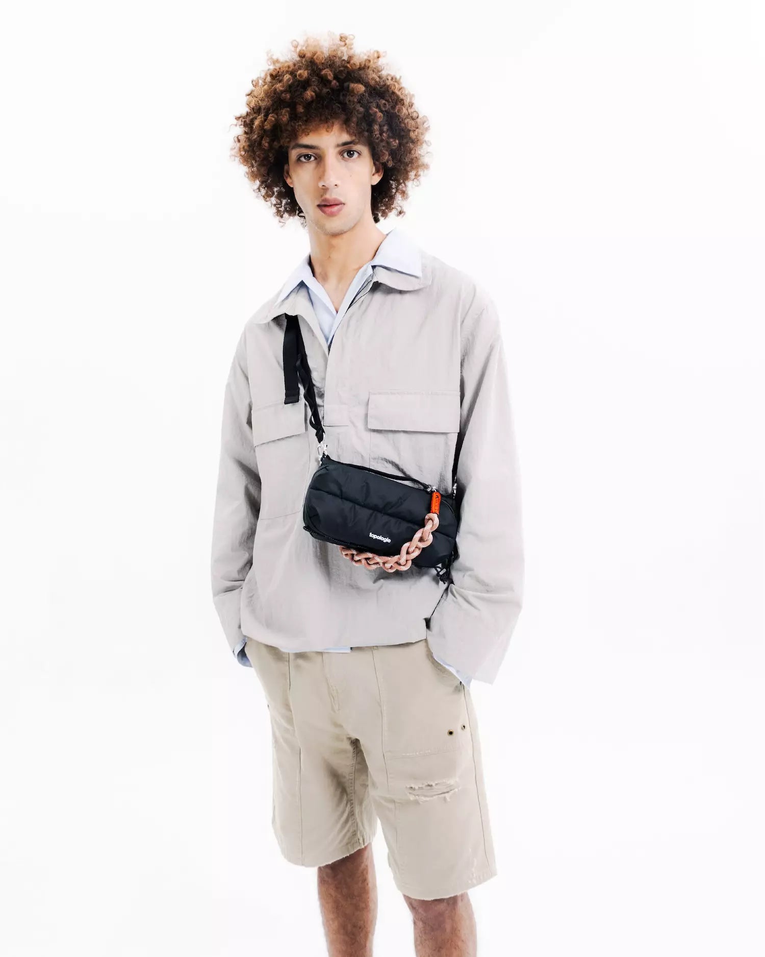 Model wearing Bottle Sacoche Medium Blue Check Wool Bag with stylish outfit.