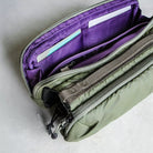 Interior view of Bottle Sacoche Medium Blue Check Wool Bag with purple lining and organized compartments for essentials.