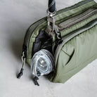 Bottle Sacoche Medium Chrome Space Coated Bag with water bottle peeking from compartment