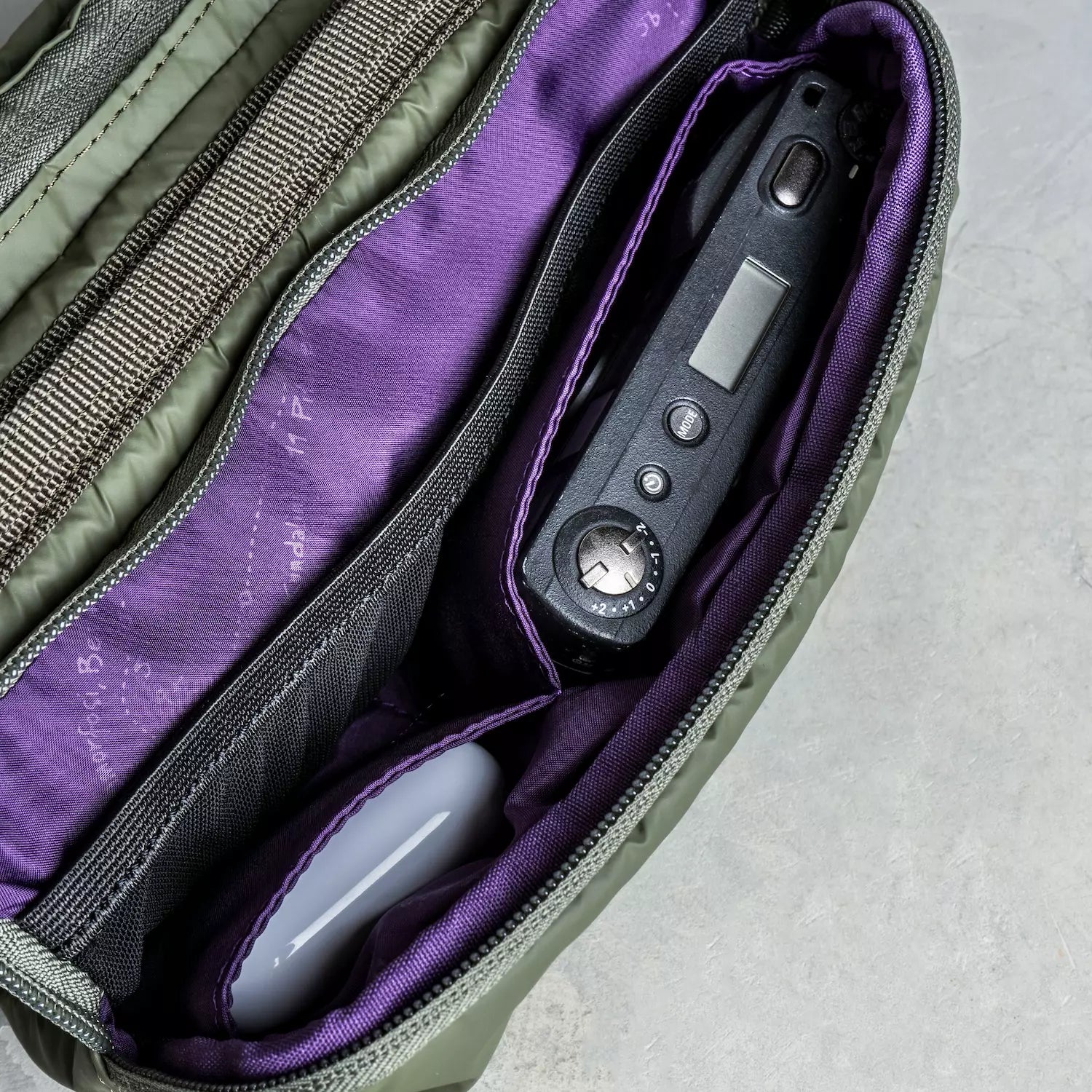 Interior view of Bottle Sacoche Medium Blue Check Wool Bag showing compartments and organizers.