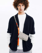 Phone Sacoche 90 Purple Washed Silk Nylon Bag worn by a model, showcasing stylish design and functionality.