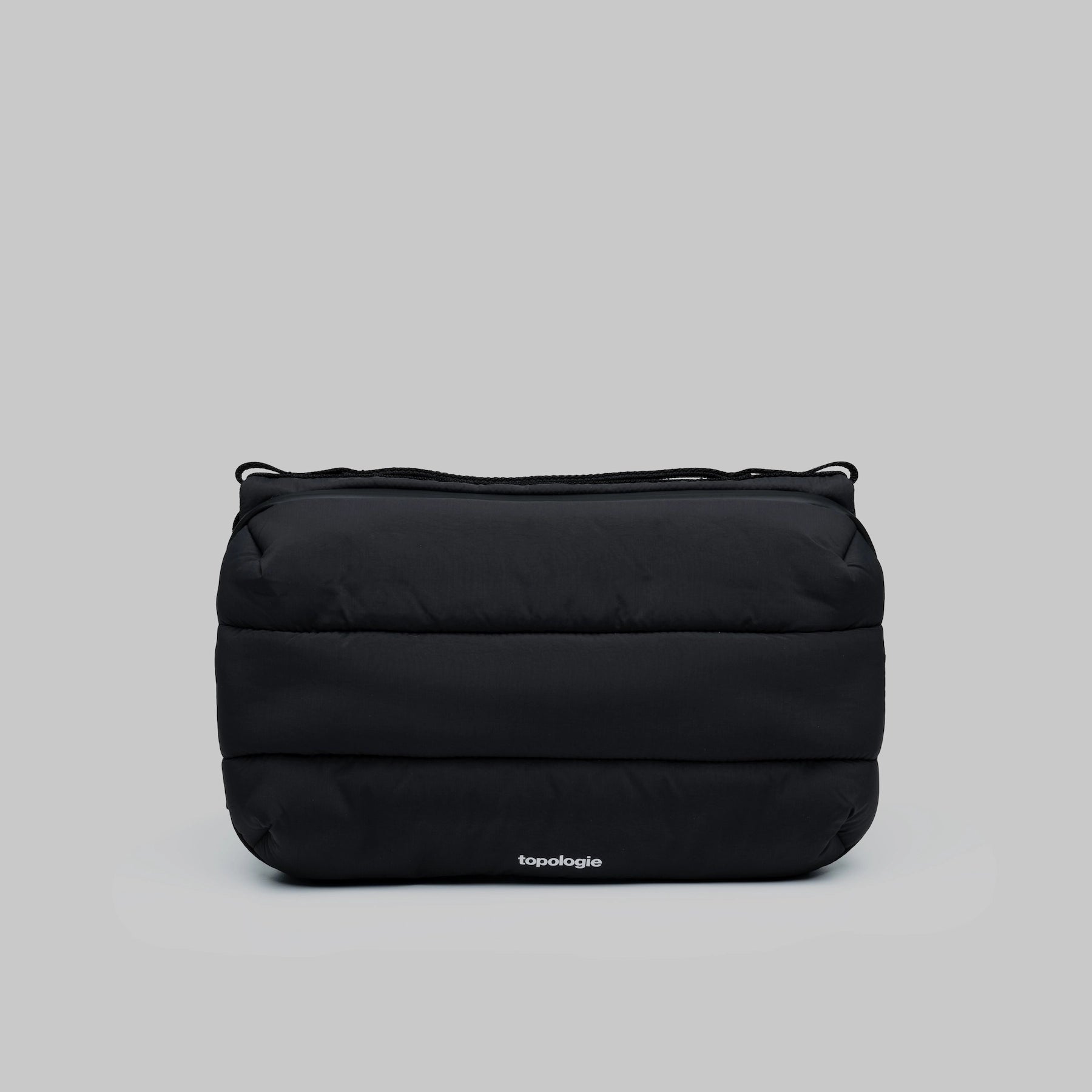 Bottle Sacoche Large Black Silky Peach Bag in durable black water repellent fabric with zipped compartments.
