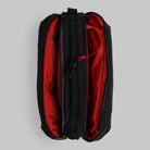 Bottle Sacoche Large Black Silky Peach Bag with red interior and zippers open, showing main compartments.