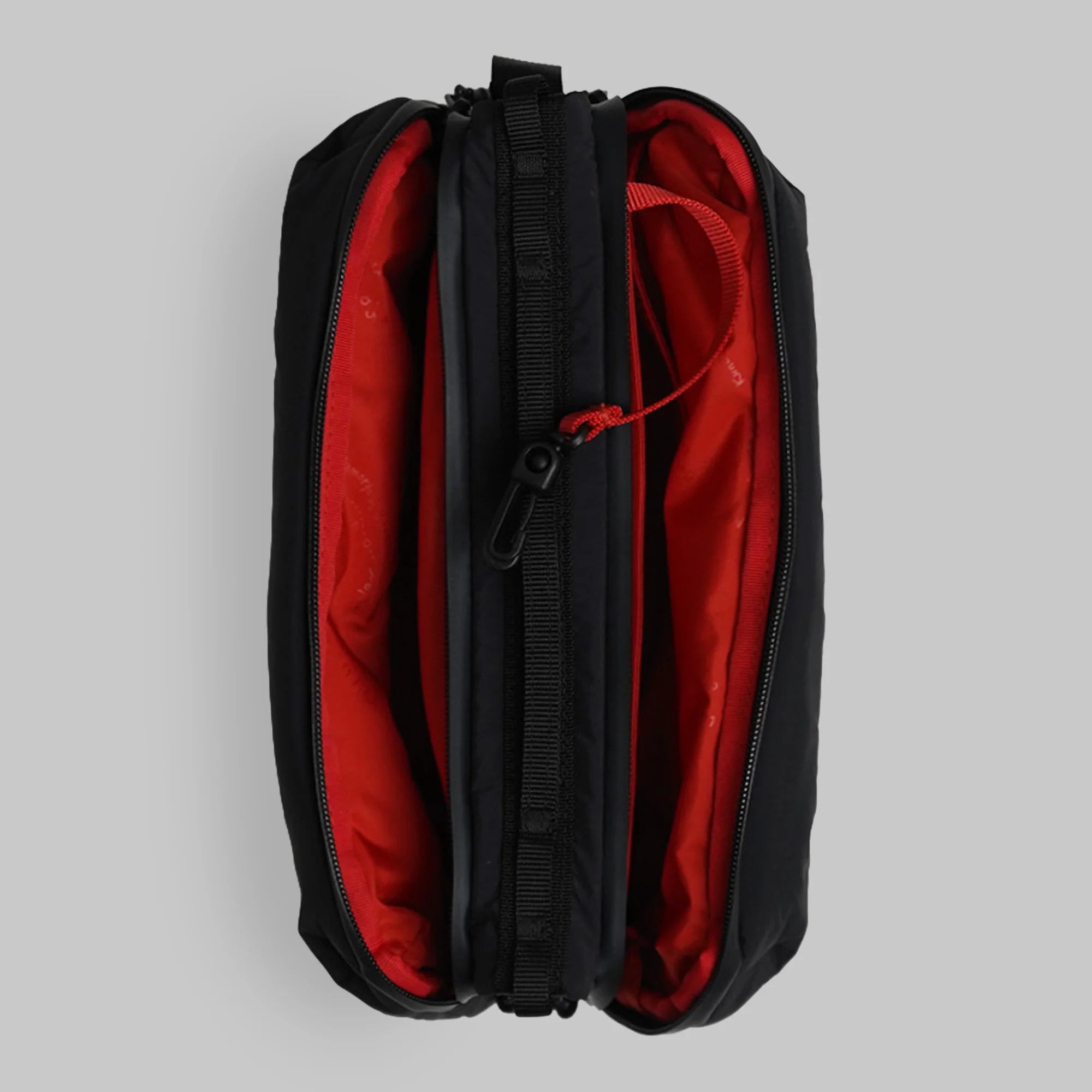 Bottle Sacoche Large Black Silky Peach Bag with red interior and zippers open, showing main compartments.