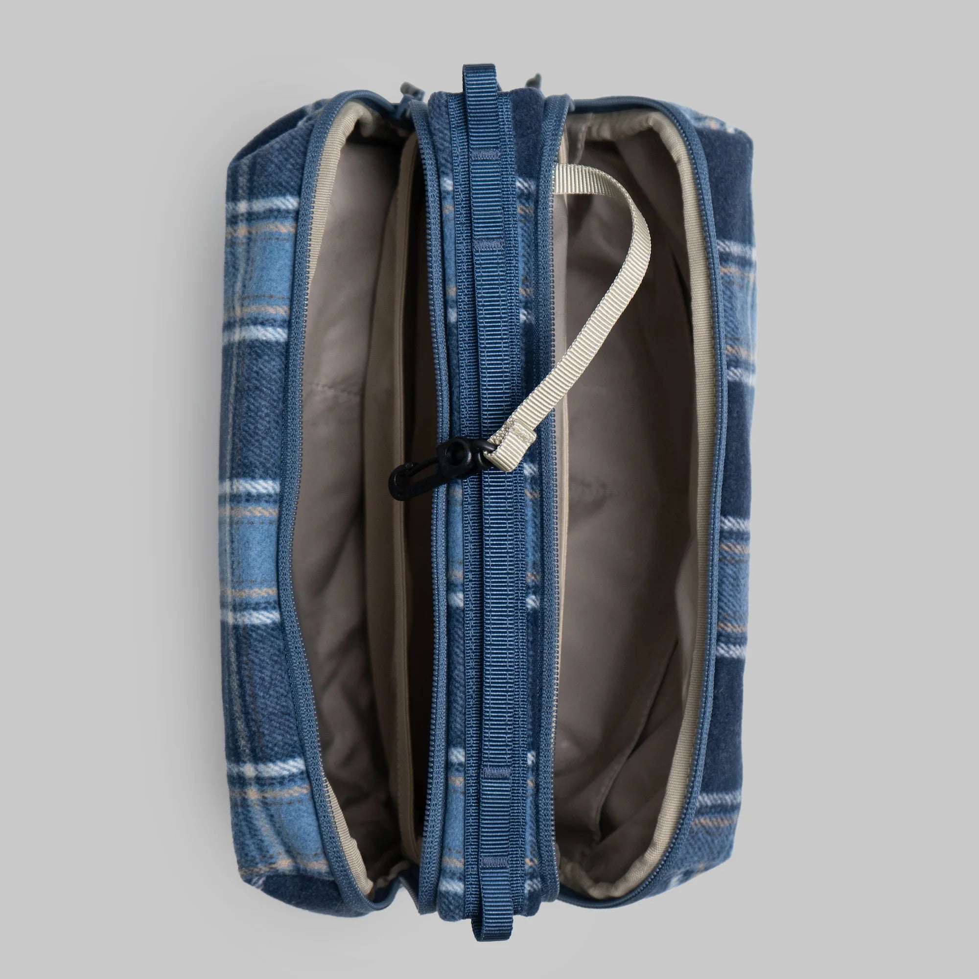 Bottle Sacoche Large Blue Check Wool Bag opened to showcase two main zipped compartments and internal organizers.