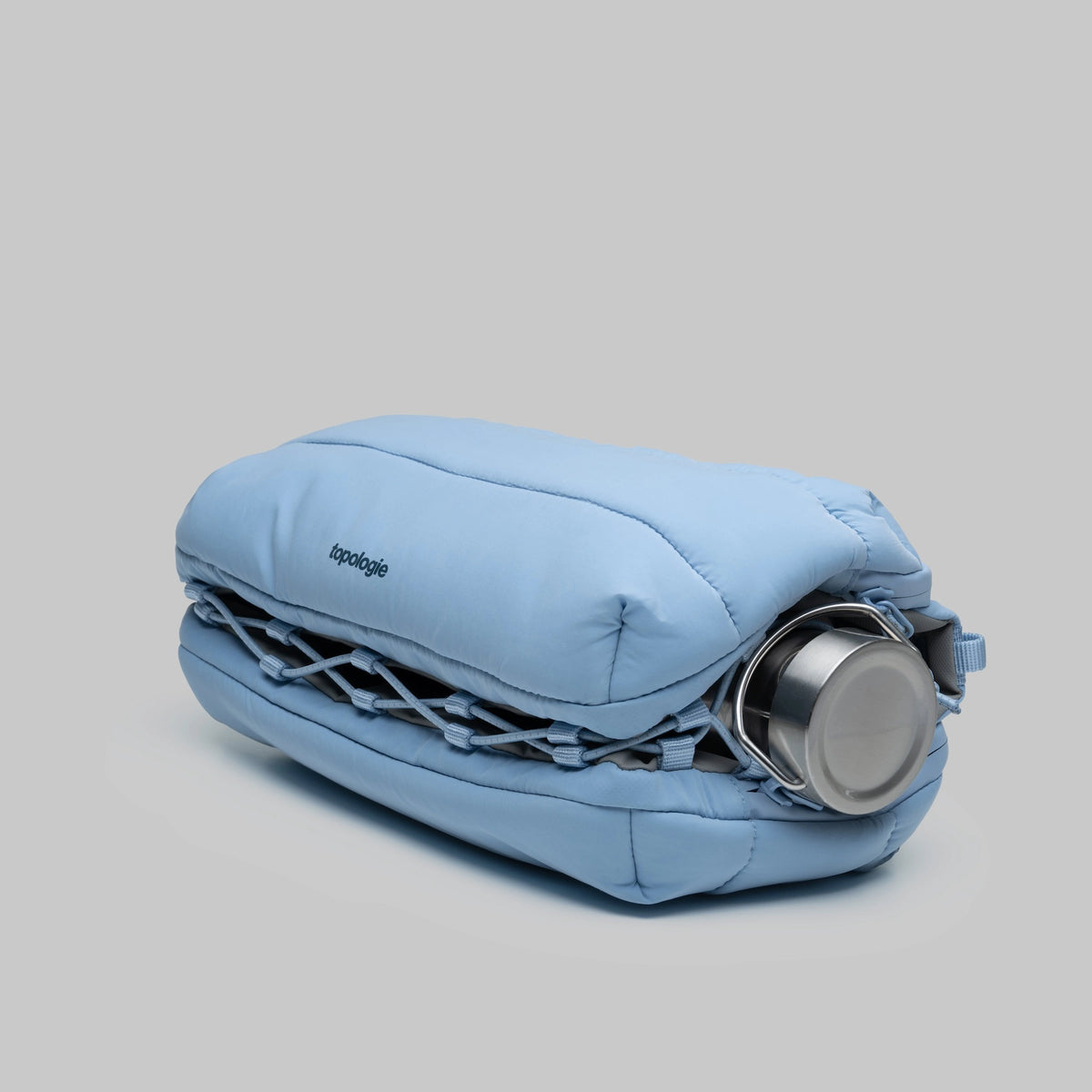 Bottle Sacoche Large Chambray Silky Peach Bag showcasing a water repellent design and bottle compartment.