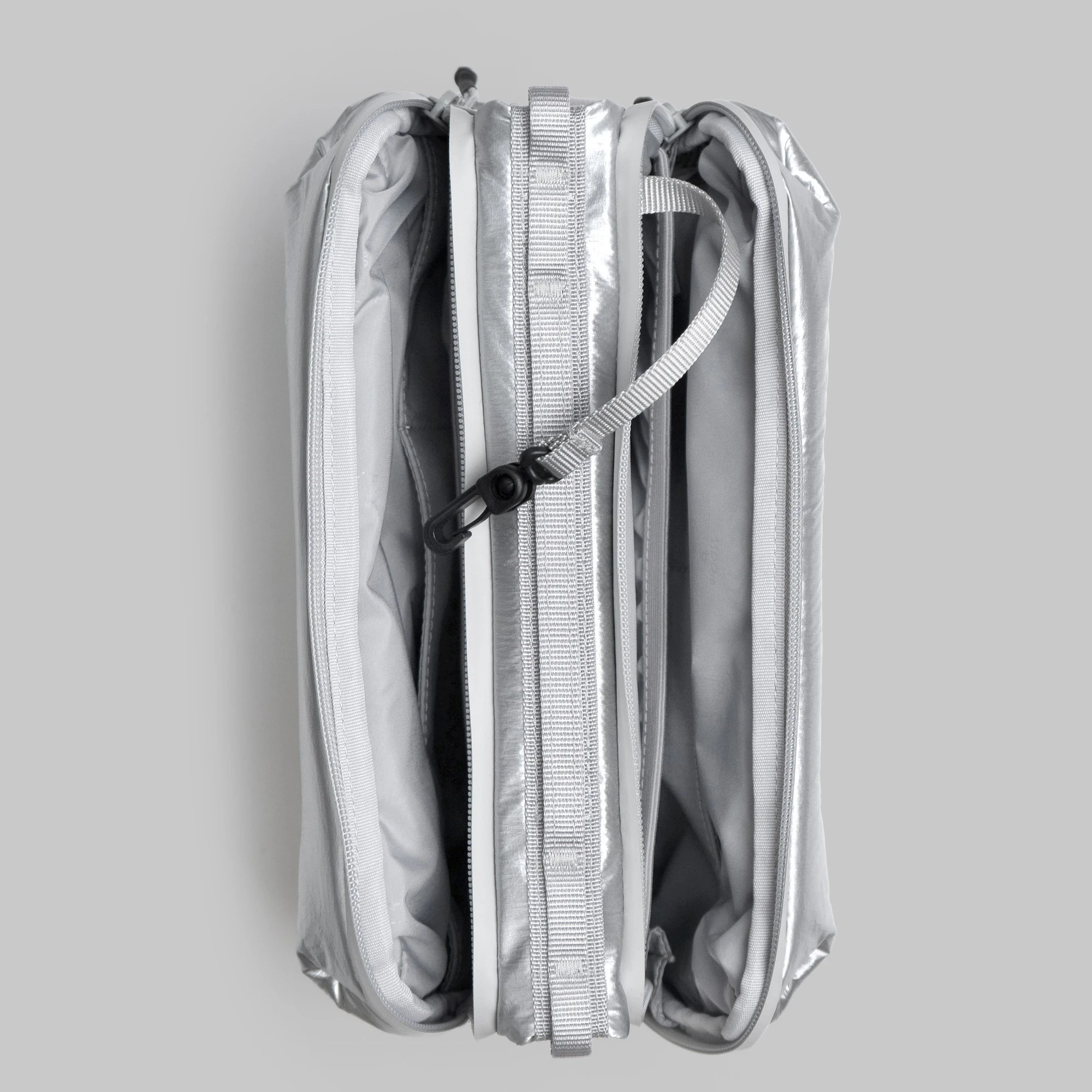 Bottle Sacoche Large Chrome Space Coated Bag folded view with zipped compartments and sleek design.