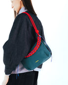 Bottle Sacoche Large Chrome Space Coated Bag in stylish colors with braided strap worn on shoulder.