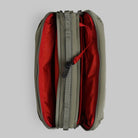Top view of Bottle Sacoche Large Moss Silky Peach Bag showing its dual zipped compartments in olive and red colors.