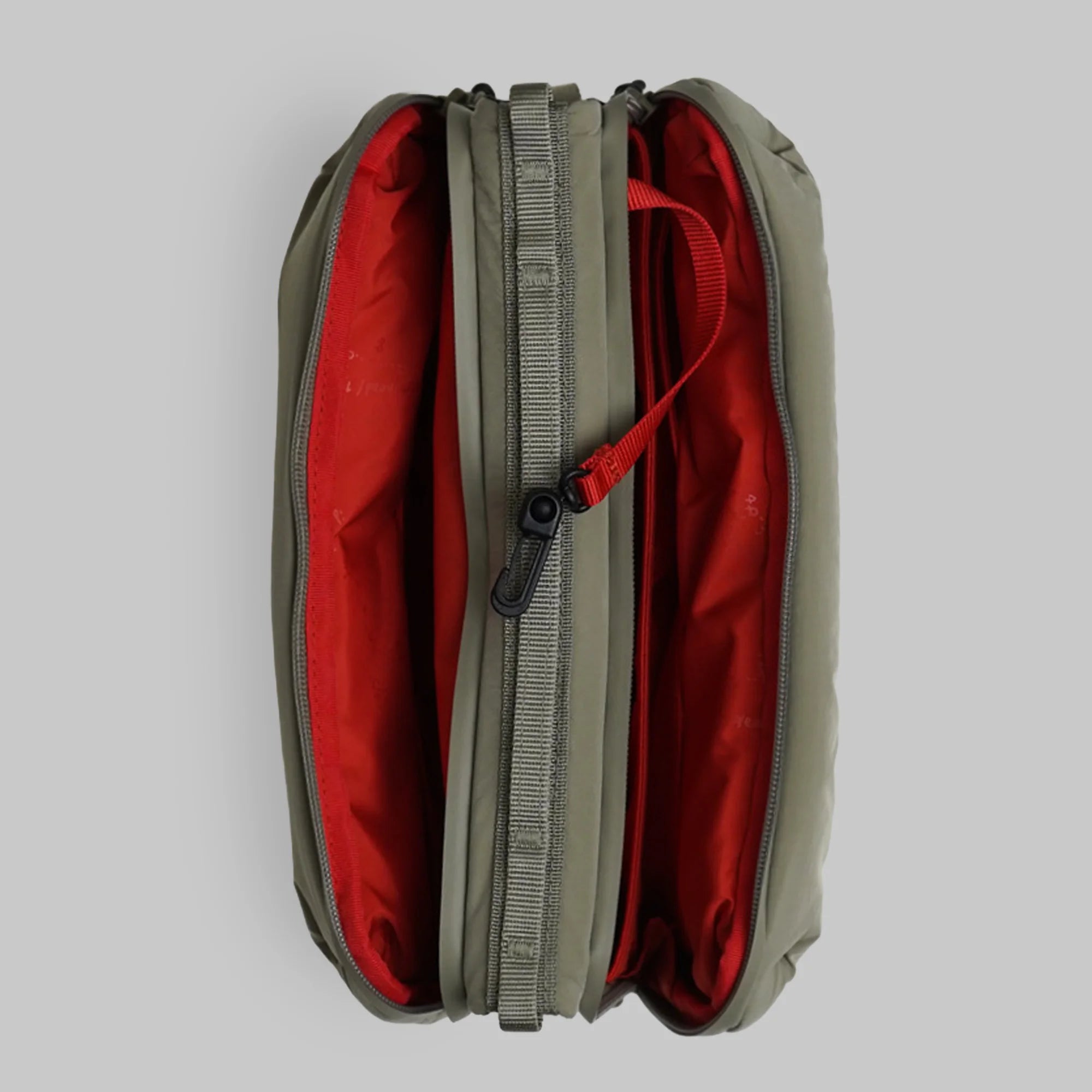 Top view of Bottle Sacoche Large Moss Silky Peach Bag showing its dual zipped compartments in olive and red colors.
