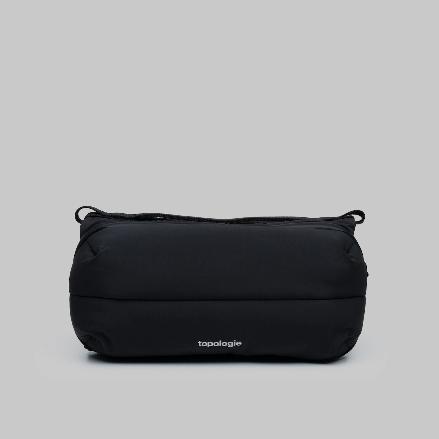 Bottle Sacoche Medium Black Silky Peach Bag in sleek black fabric with Topologie branding.