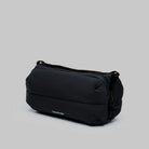 Bottle Sacoche Medium Black Silky Peach Bag in black with sleek design for carrying bottles.