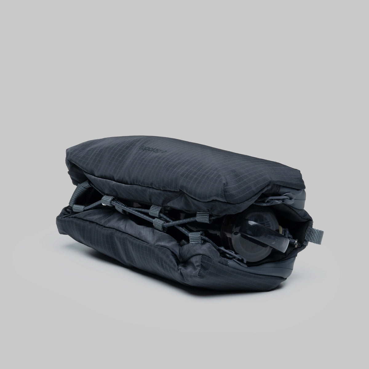 Bottle Sacoche Medium Burnt Ash Vintage Ripstop Bag folded with bottle storage and pockets, compact design.