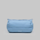 Bottle Sacoche Medium Chambray Silky Peach Bag in a light blue color with a sleek design.