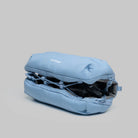 Bottle Sacoche Medium Chambray Silky Peach Bag in light blue color, showcasing its compact design and water repellent fabric.