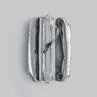 Bottle Sacoche Medium Chrome Space Coated Bag open showing compartments and zippers.