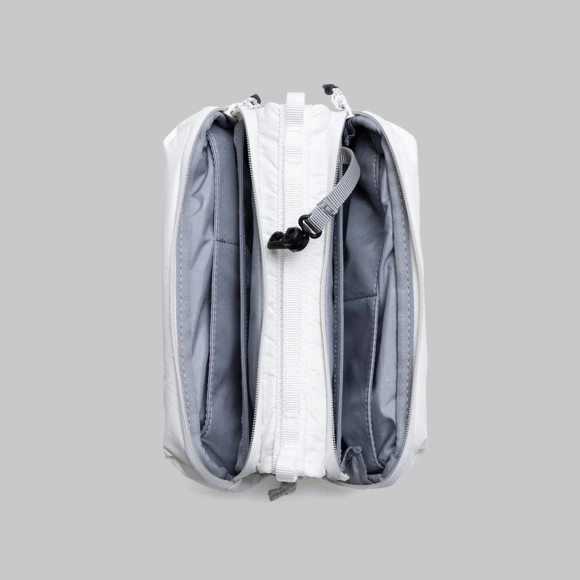 Bottle Sacoche Medium Ecru Matt Coated Bag showing two main zipped compartments and internal pockets.