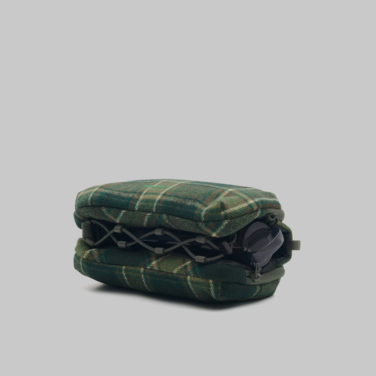 Bottle Sacoche Medium Green Check Wool Bag side view showing zipped compartments and green check design.