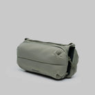 Bottle Sacoche Medium Moss Silky Peach Bag in soft green fabric with compartments for bottles and umbrellas.