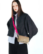 Bungee Strap Spruce Tech Sateen worn by model, showcasing adjustable length and lightweight design.