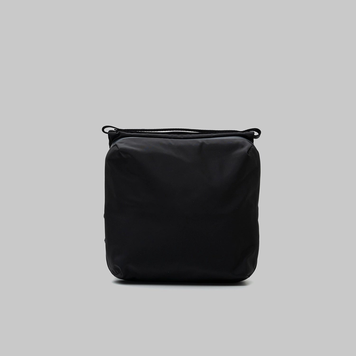 Cassette Sacoche Medium Black Tech Sateen Bag front view, showcasing its sleek design and water-resistant fabric.