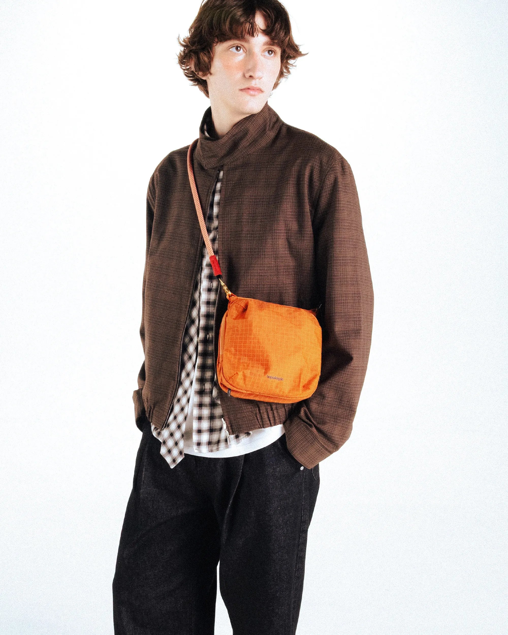 Model wearing the Cassette Sacoche Medium Moss Tech Sateen Bag in a stylish outfit.