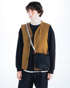Cassette Sacoche Medium Moss Tech Sateen Bag worn as a crossbody bag by a model in casual outfit.