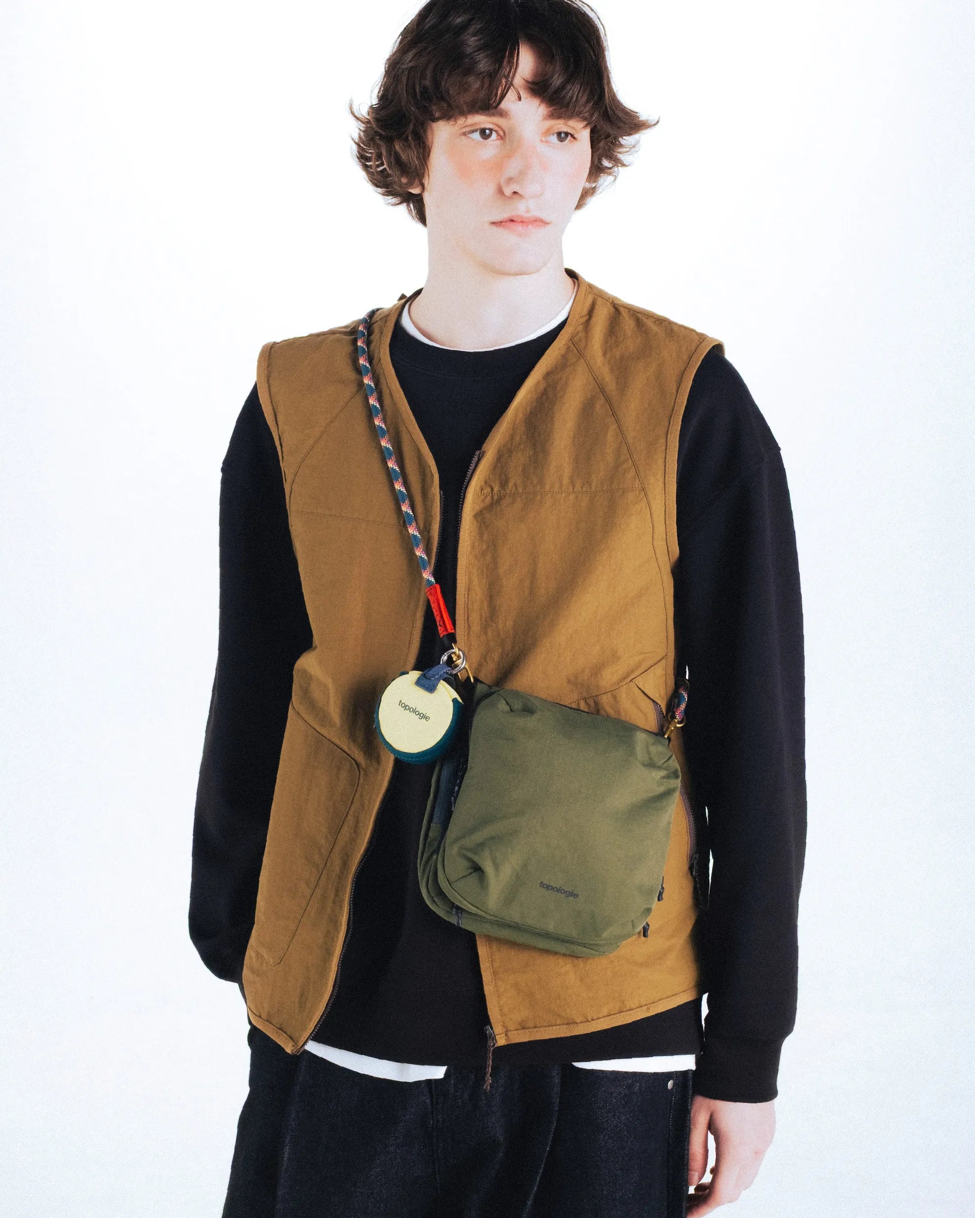 Model wearing a Cassette Sacoche Medium Black Tech Sateen Bag with a crossbody strap.