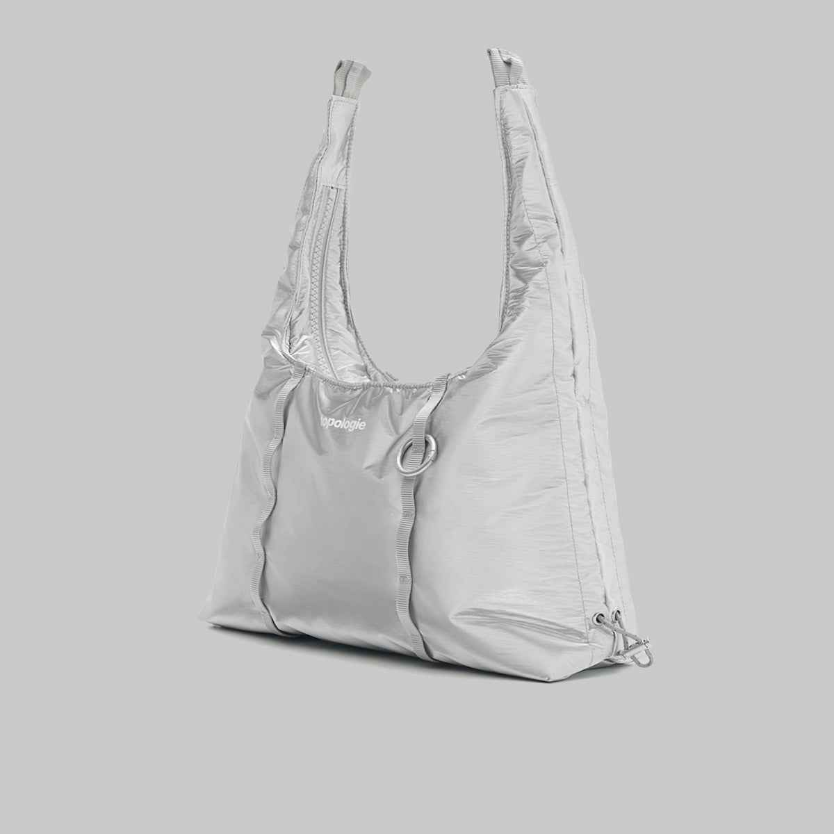 Cloud Hobo Small Chrome Space Coated Shoulder Bag on gray background, showcasing zipped main compartment and drawstring design.