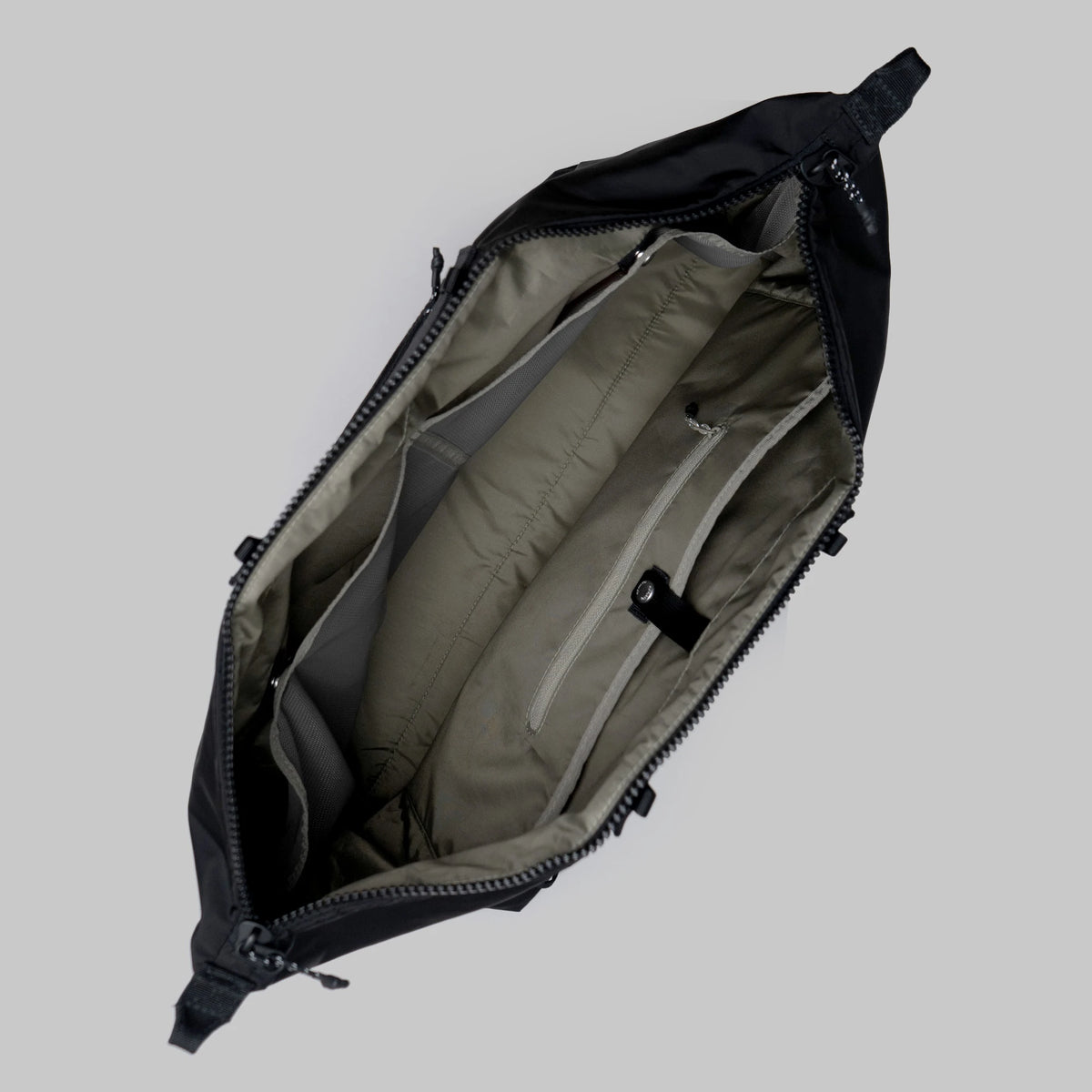 Interior view of the Explorer Tote Weekender Black Tech Sateen Shoulder Bag showing compartments and zipper pockets.