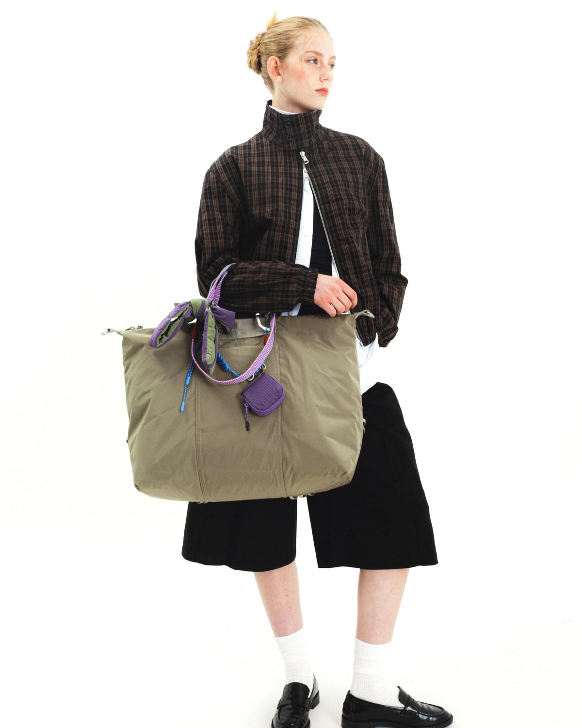 Explorer Tote Weekender Black Tech Sateen Shoulder Bag being modeled with casual outfit, showcasing its versatile design.