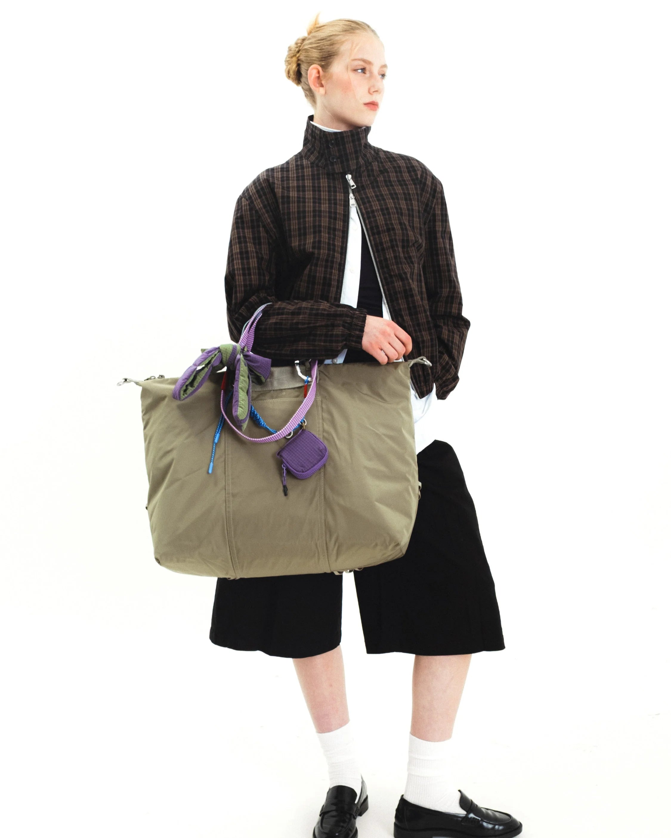 Explorer Tote Weekender Moss Tech Sateen Shoulder Bag in use by model with stylish outfit.