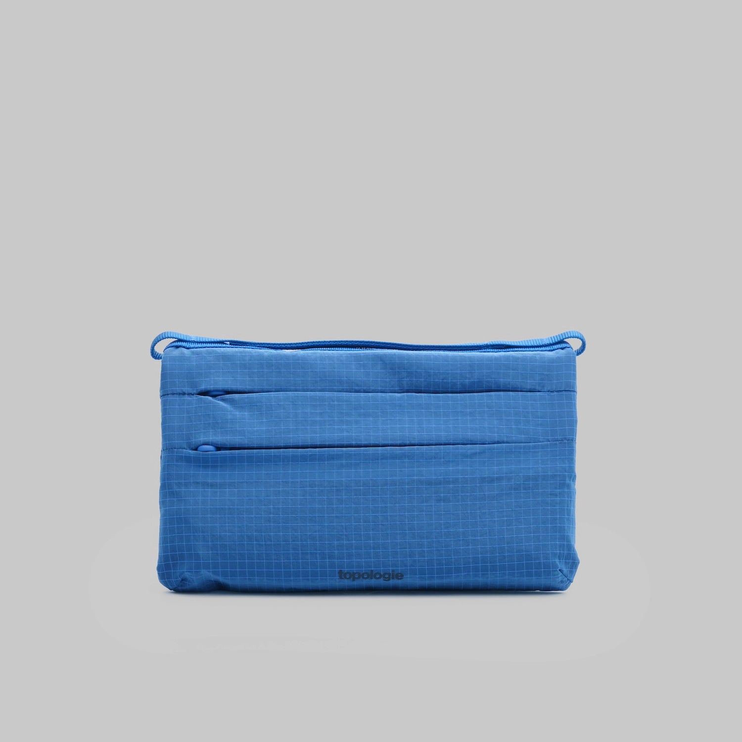 Flat Sacoche Small Sonic Vintage Ripstop Bag in blue with zipped compartments and water repellent fabric.